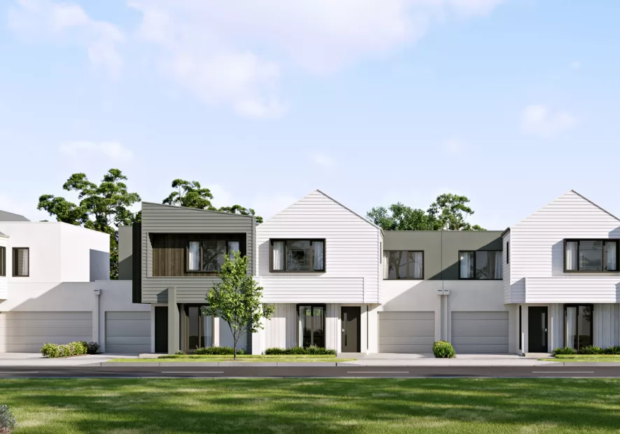 A bank of six white and grey townhomes, green grass and blue sky